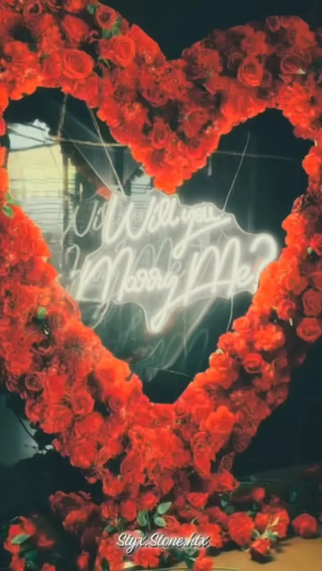 Proposal-themed rose-heart installation reading marry me at Styx + Stone