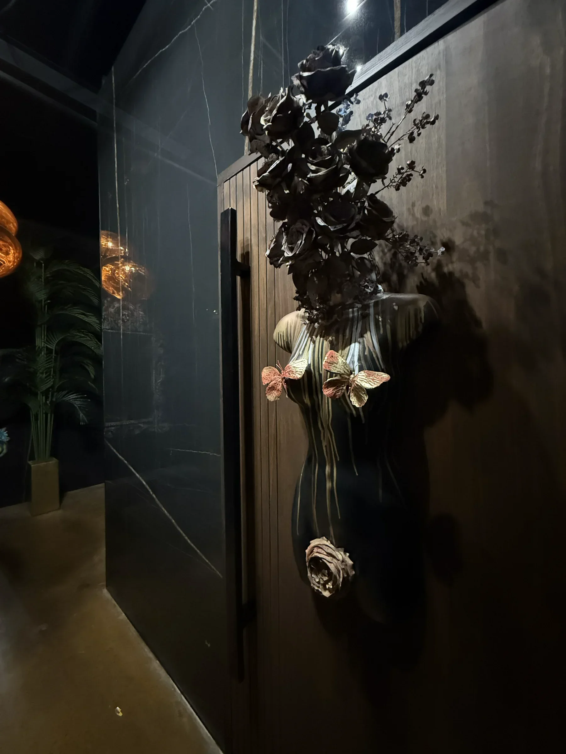 Black floral sculpture detail on the marble wall in the ground-floor bar at Styx + Stone